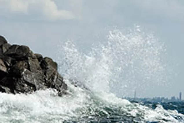 Ocean waves hitting rocks. Photo.